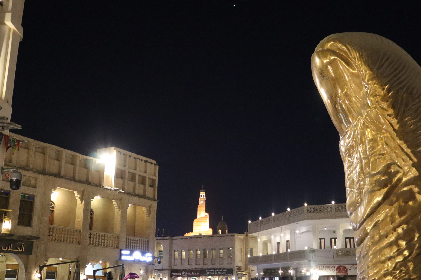 The famous Souq Tower seen from a distance near the famous thumb sculpture. 